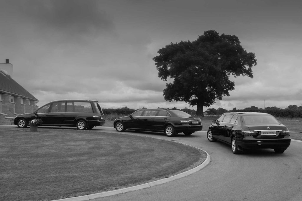 Procession of hearse and limousines